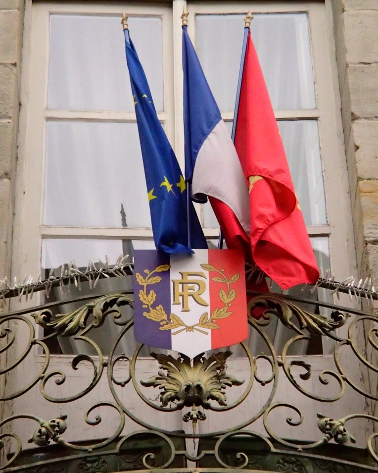 The  flags of the European Union, France, and Languedoc region outside the Mairie (Town Hall.)